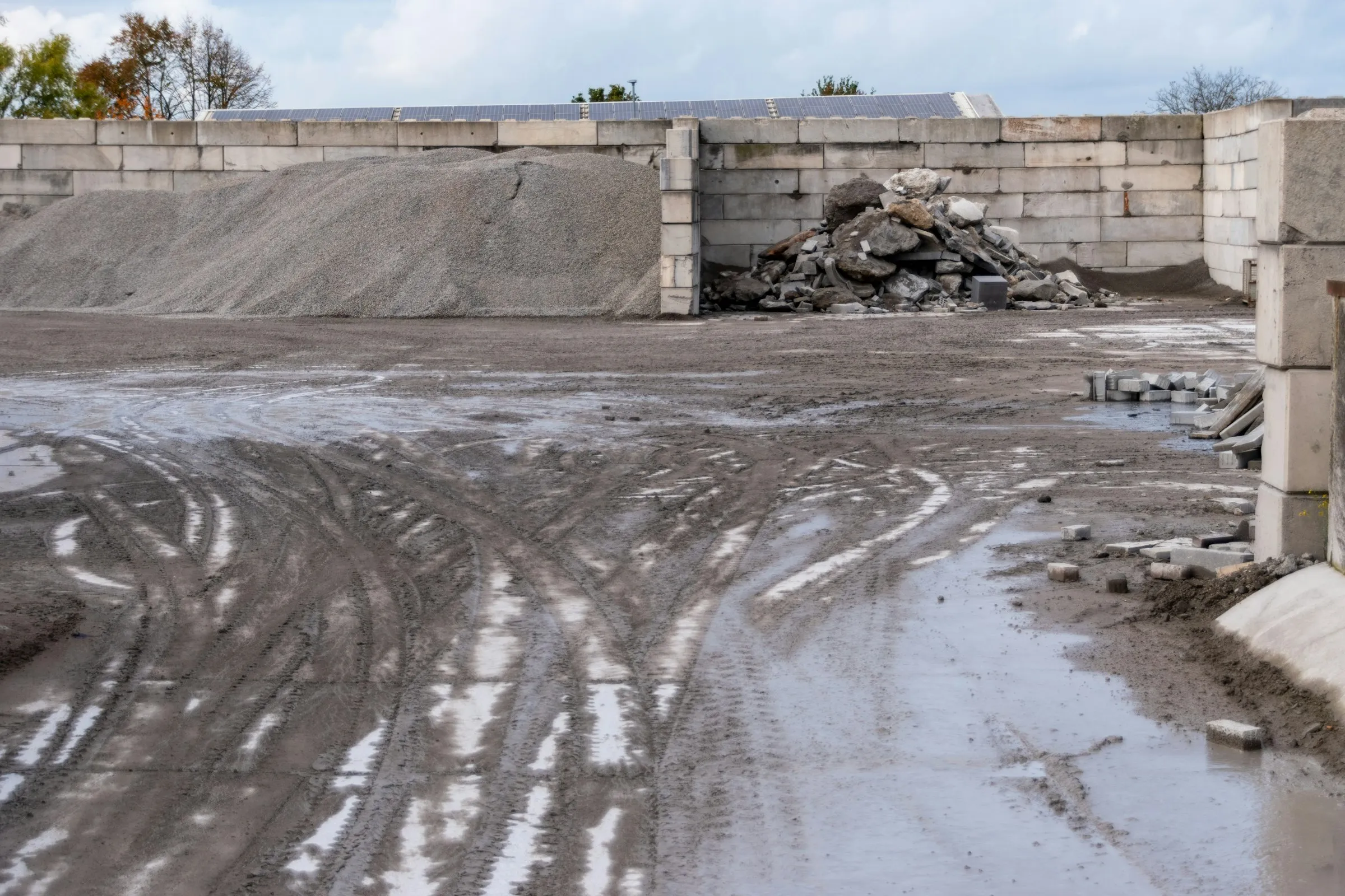 Driveway before the work: uneven ground with ruts and remains of the old surface